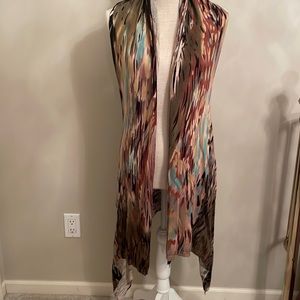 Multi color sweater vest with long tails in front. Size M